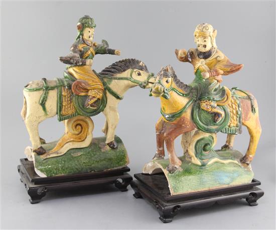 A pair of Chinese sancai glazed pottery ridge tiles, Ming dynasty, height 34cm and 34.5cm, losses, wood stands